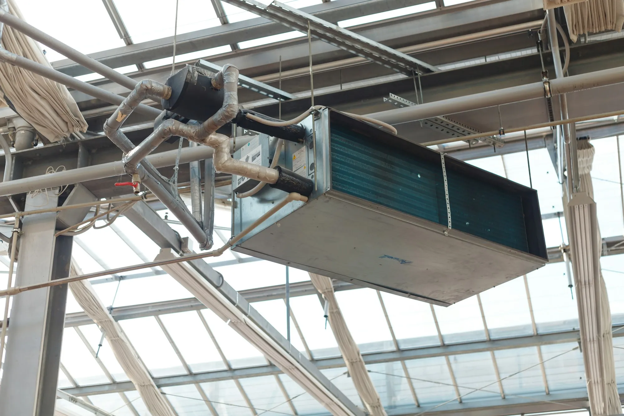 Suspended air handling unit under a glass roof